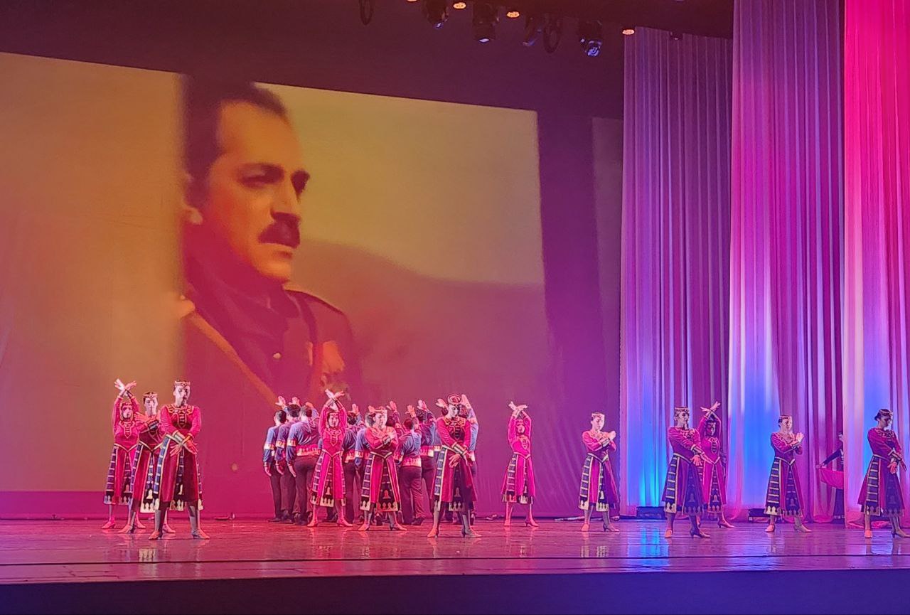 «Զվարթնոց» պարի խմբի տղանները Օպերայում արիական ողջույնն են անում Նժդեհի (գեղարվեստական ֆիլմից) պատկերի դիմաց...